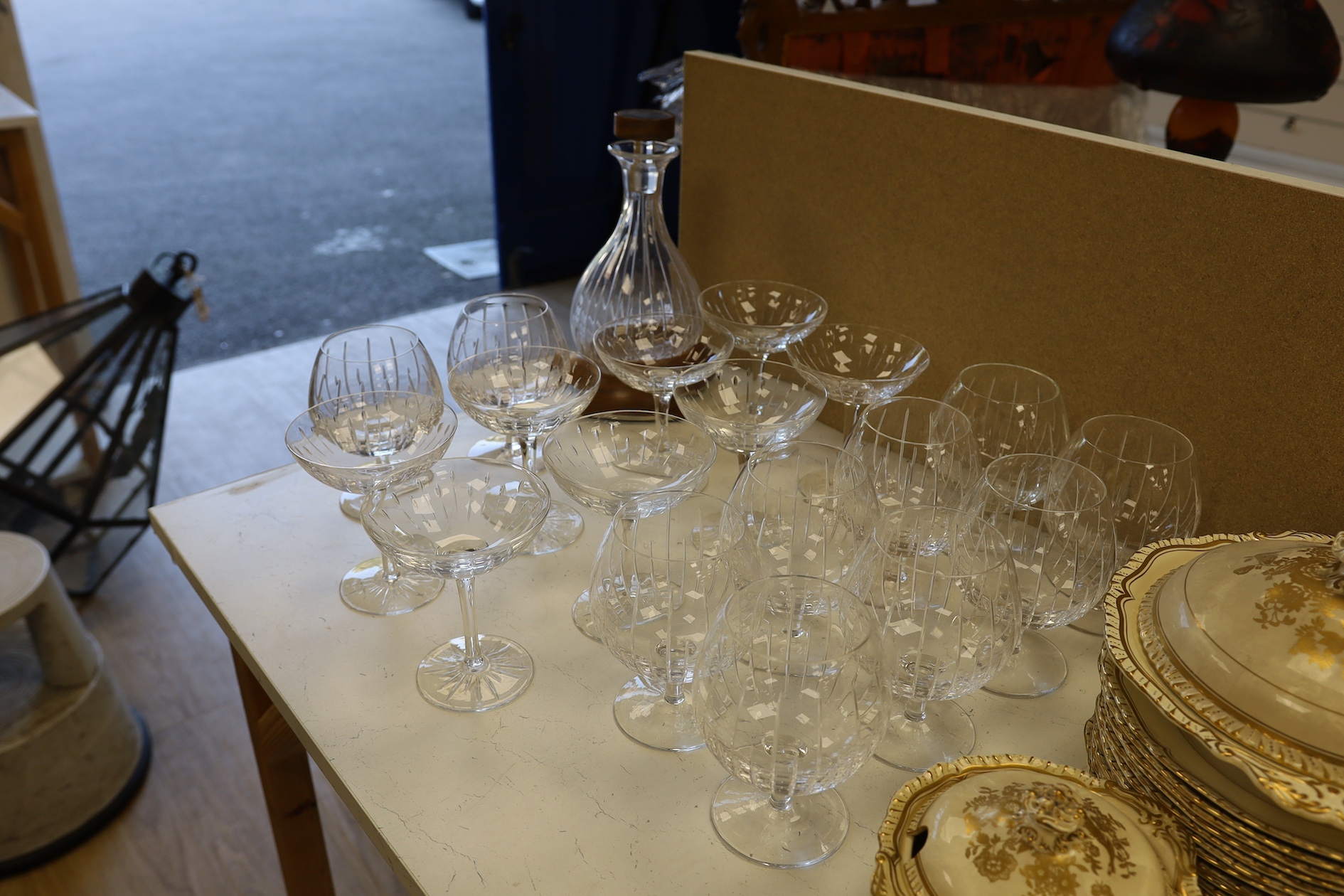 A Linley Glyndebourne pattern cut glass decanter with a silver mounted stopper, on a weighted wooden coaster stand, and a matching set of ten goblets, and eight champagne coupes, largest 30cm high. Condition - all in ver